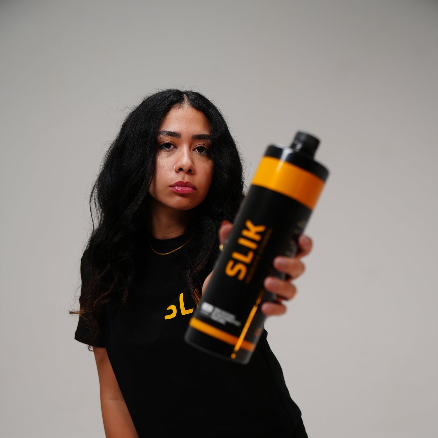 Person holding a Slik product against a plain background
