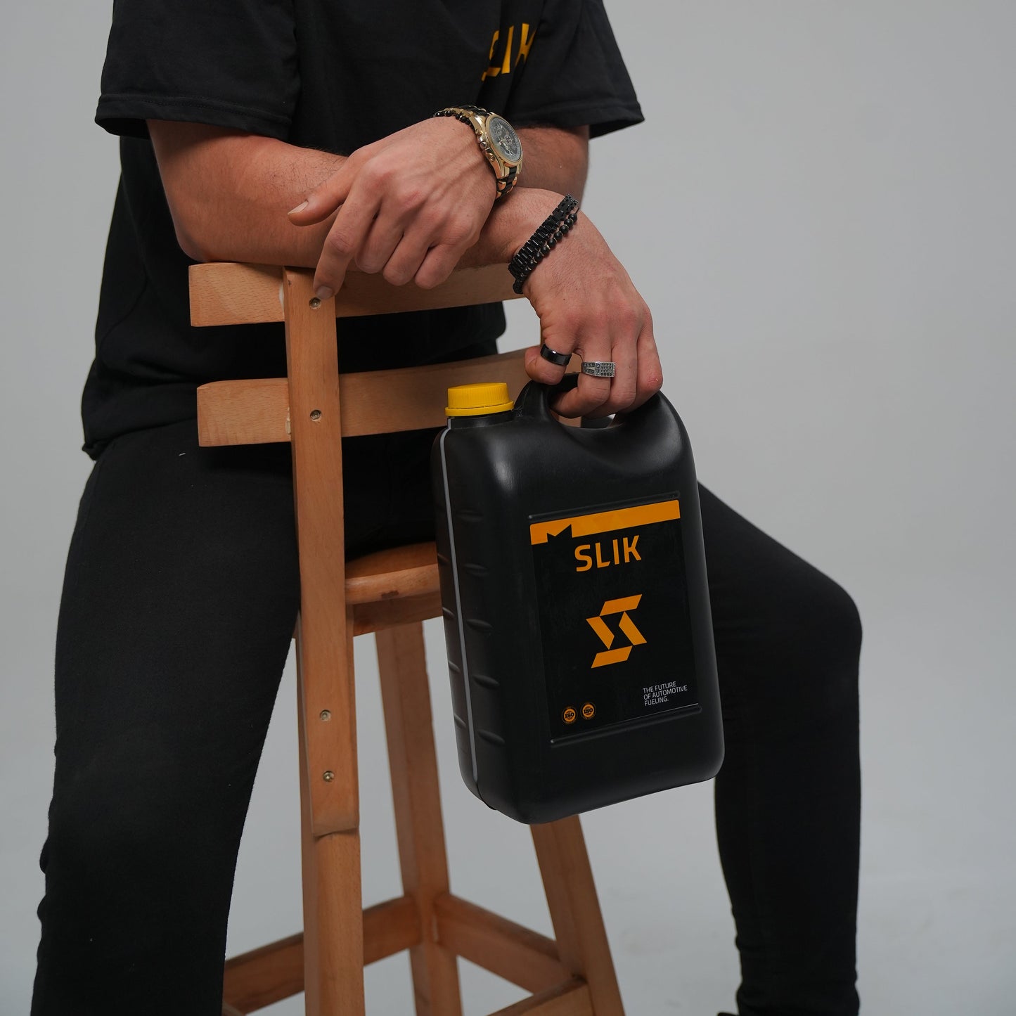 Man holding a digital scale against a gray background